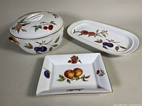 Three Royal Worcester Evesham pieces: covered casserole, oval platter, rectangular dish