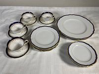 Group of teacups, saucers and stacked plates