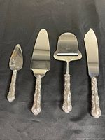 All four sterling-handled utensils laid out