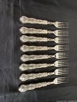 Set of eight matching luncheon forks aligned