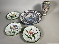Group shot of vase, platter, three wall plates