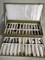 open case displaying agate instruments in individual silk slots