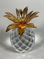 Front view of entire crystal pineapple showing faceted body and hammered gold-tone leaves
