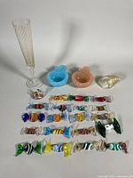 Group shot of all items including flute, ashtrays, candies, seashell