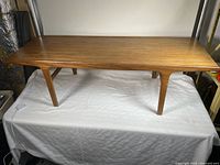 Full view of teak coffee table top and legs