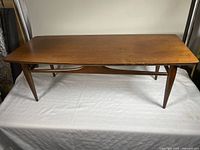 Full top view of walnut coffee table showing overall form and surface wear