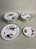 Stacked dinner and side plates plus two samples showing motif and rim