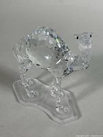 Full view left side of faceted crystal camel on frosted base