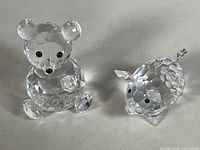 bear and pig figurines side by side