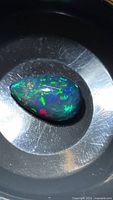 Pear cabochon Ethiopian black opal showing green, blue and red play-of-color