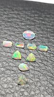 All eight faceted opals laid out showing shapes and colour play