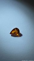 Pear-cut orange garnet on white background
