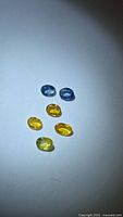 six loose oval sapphires in blue and yellow