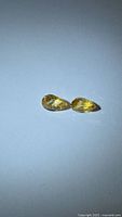 both pear-cut yellow sapphires side by side