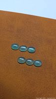Six oval green onyx cabochons arranged in two rows