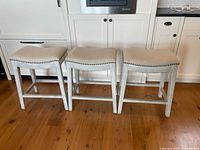 Three matching counter stools side by side