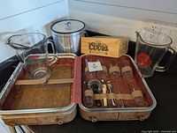 Overall lot showing both pitchers, ice bucket, wooden Coors box, and open suitcase bar set with tools and cups