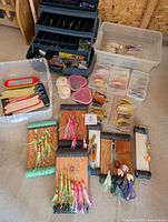 Full lot showing tackle box, tote, divided boxes, wooden boards with lures