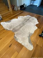 Full view of cowhide rug on hardwood floor