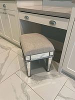 Full view of mirrored vanity stool under counter