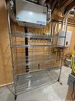 full view of five-shelf chrome wire unit in basement
