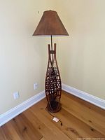 Full view of snowshoe floor lamp against wall