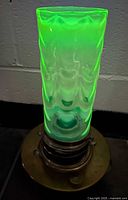 Lamp assembled, shade glowing green under UV showing uranium content