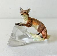 Front view of resin fox on clear glass base