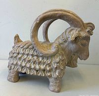 Front left view of ram sculpture showing horns and fleece texture