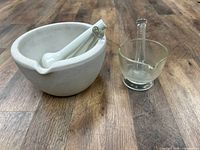 Ceramic and glass mortar & pestle sets side by side