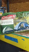 Front of green carry bag showing Coleman branding, Highline Dome Tent name, capacity and dimensions