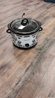 Front view of Crock-Pot slow cooker showing damask pattern, glass lid, power cord