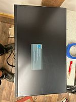 Front view of Dell U2414H monitor powering on with OSD window visible