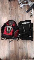 Front view of both backpacks showing SwissGear logo and Battlefield 1 flap