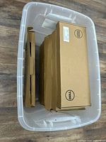 Dell keyboard boxes stacked in clear tote
