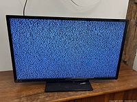 Front view of Sansui TV displaying static on screen