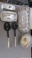 All six items laid out: metal tray, butter dish set, two utensils, glass bowl, ceramic dish