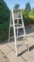 Front angled view of aluminum step ladder showing height, steps, and overall condition
