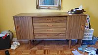 Front view showing full sideboard with drawers and sliding doors closed