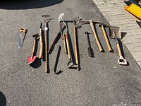 All 15 tools laid out on pavement for overview