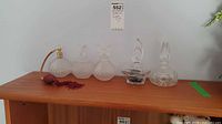 Five perfume bottles on shelf showing overall lot