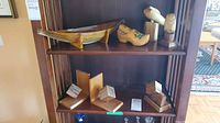 Shelf view showing tray, clog, figurines, pair of bookends