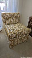Front three-quarter view of armless floral upholstered chair