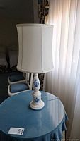 Full view of lamp with shade on table