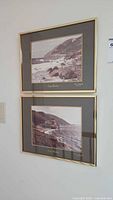 Two framed Cape Breton photographs hanging on wall