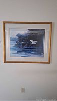 Front view of framed Ken Carlson bird print on wall