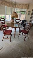 Full view of round wood table with four chairs