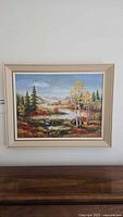 Full view of framed landscape painting on wall