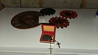 Overview of zodiac plate, rosaries, presentation box, three sunflower plaques