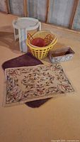Overall lot showing laundry basket, side table, rugs, planter and basin